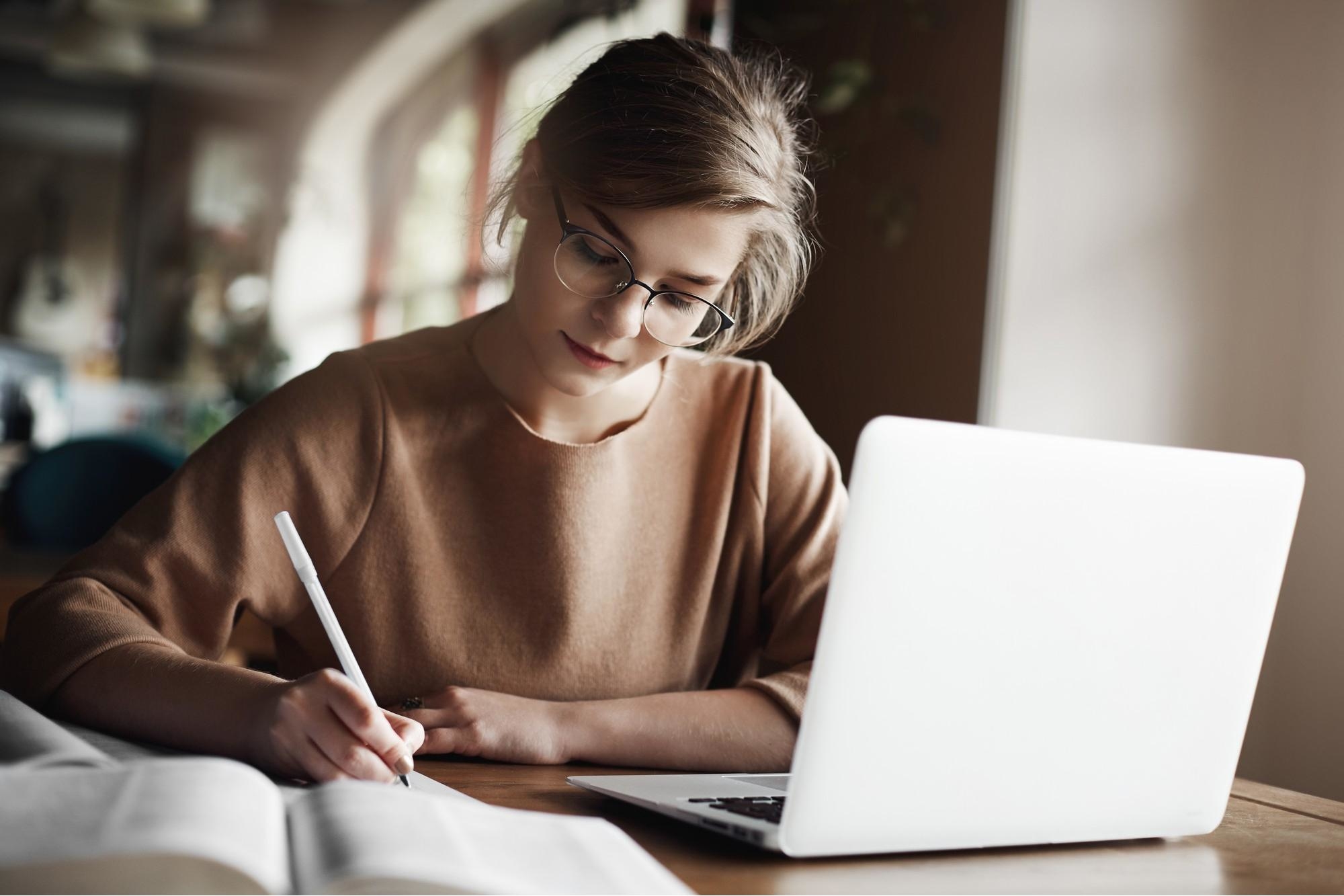 Focused woman concentrating writing essay