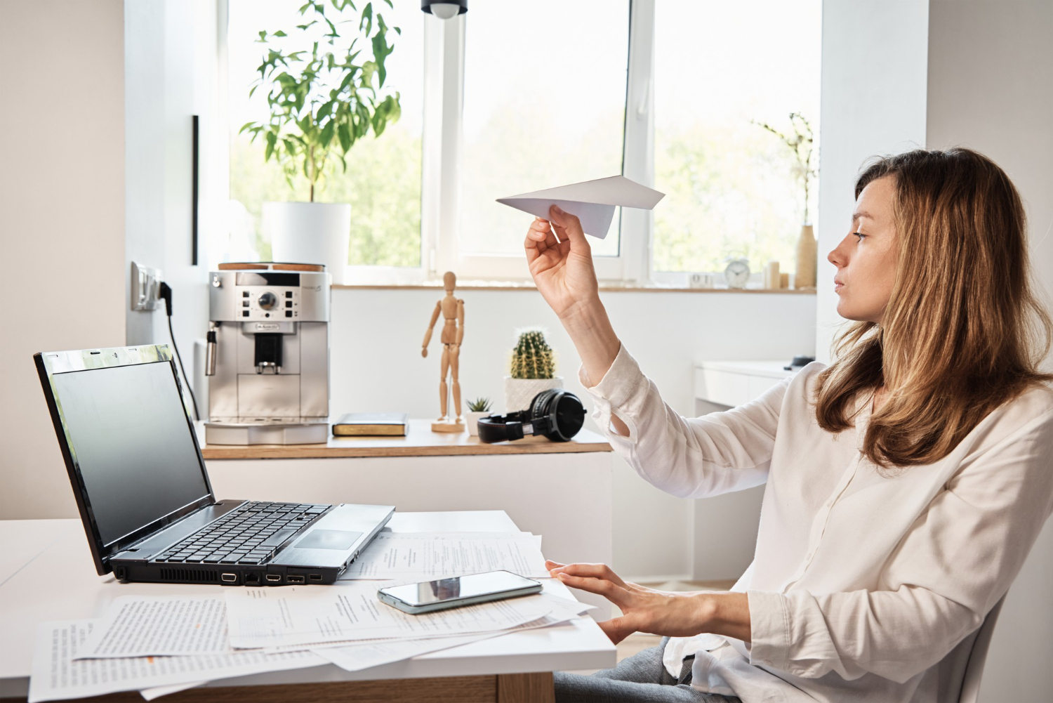 Woman plays with paper plane