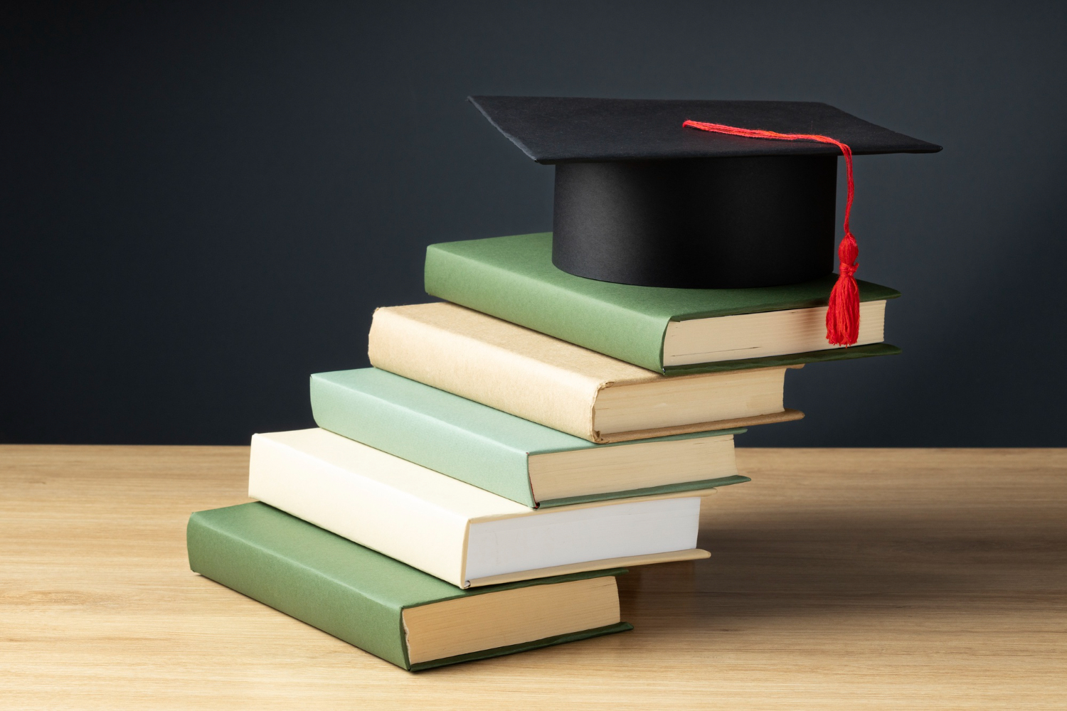 Graduation cap on top of books